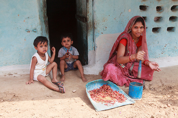 Indian Woman Grinding Red Peppers